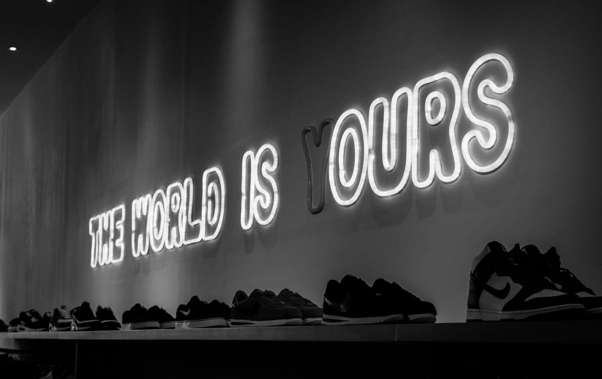 Neon sign reading “THE WORLD IS YOURS” with the 'Y' unlit.