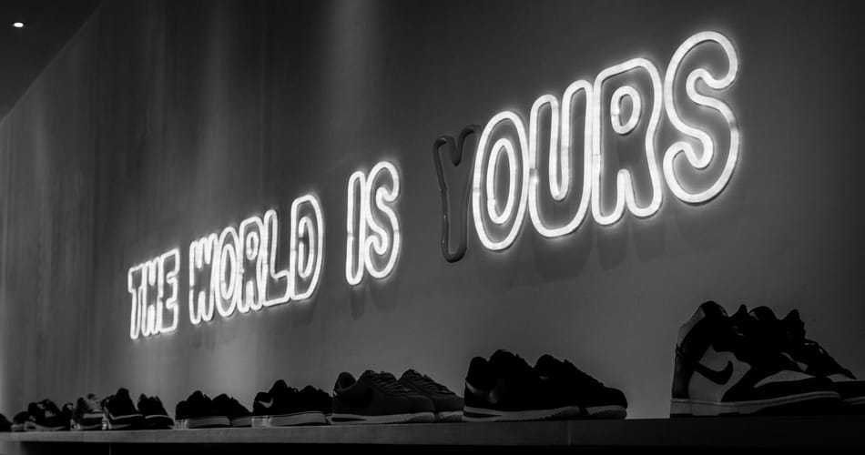 Neon sign reading “THE WORLD IS YOURS” with the 'Y' unlit.